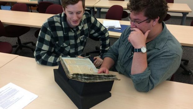 Erik and Cole examining one of the Sylvester scrapbooks (Photo by E. McGuire)