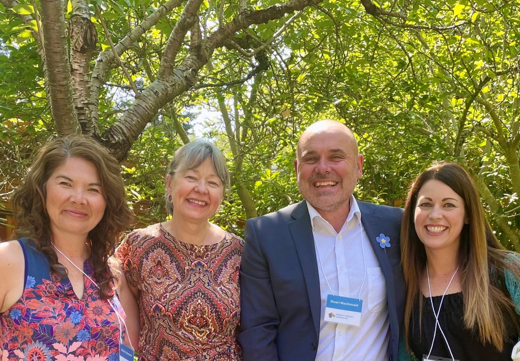 Dr. Mariko Sakamoto, Dr. Denise Cloutier, Dr. Stuart MacDonald, and Dr. Jodie Gawryluk standing in a row in front of some trees.