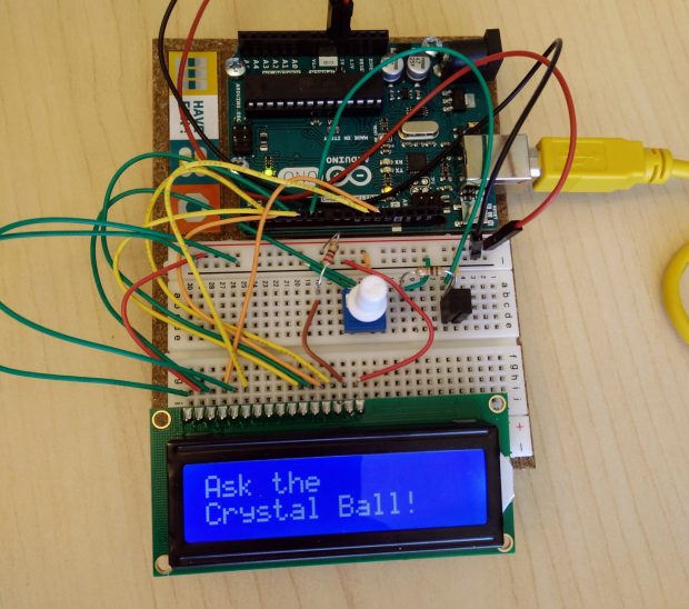 Photo of Arduino project called Magic 8 Ball with a digital screen that says "Ask the Crystal Ball!"