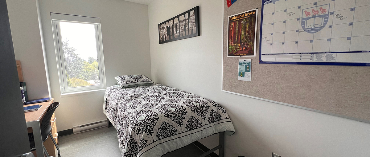 A photo graph of a single bed in a UVic dormitory.