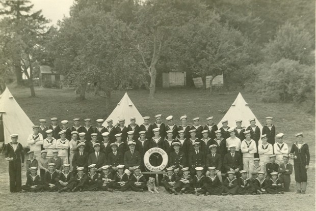 The annual picture of the ship's company shows the size of the Corps and includes the Officers, Instructors, members and the ship's dog. Circa 1935