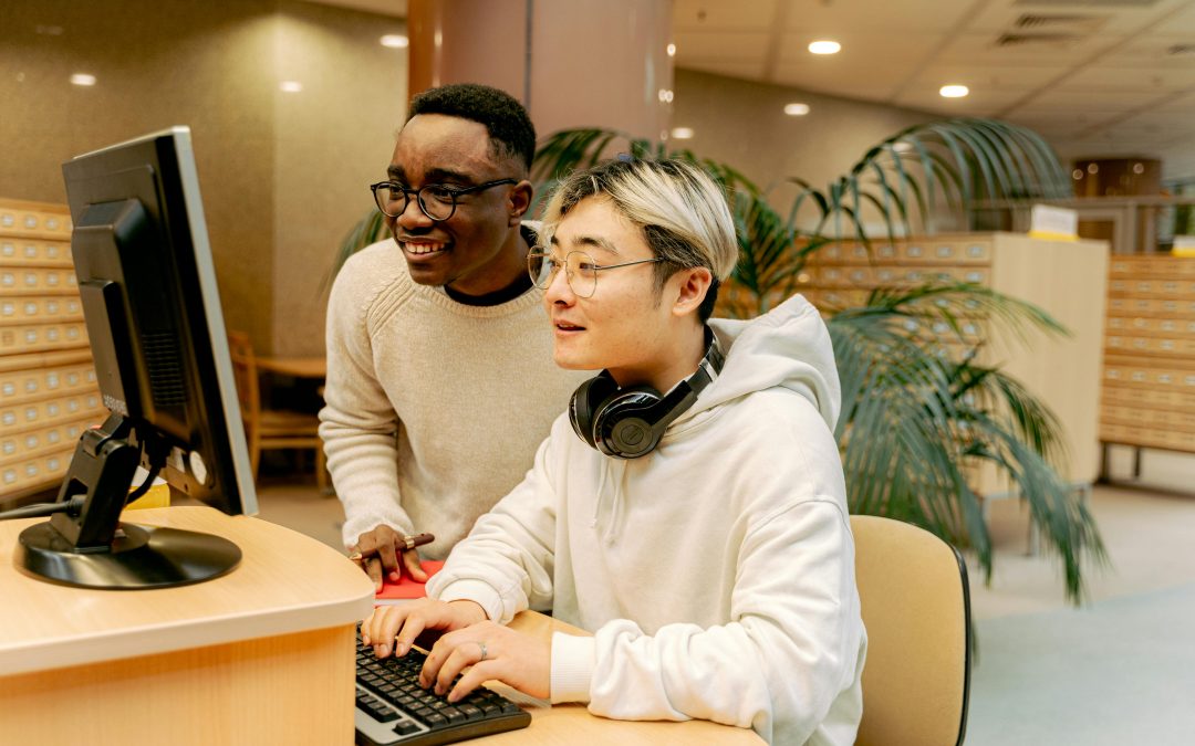 Librarian helping internation student with computer