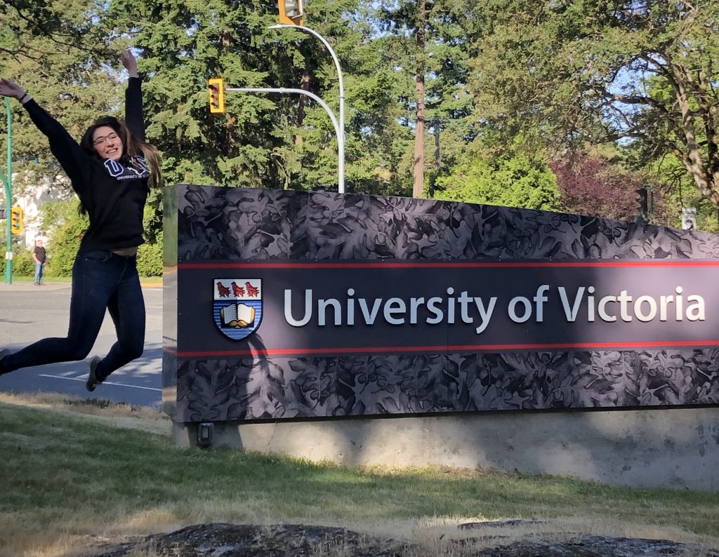 University of Victoria sign with jumping woman
