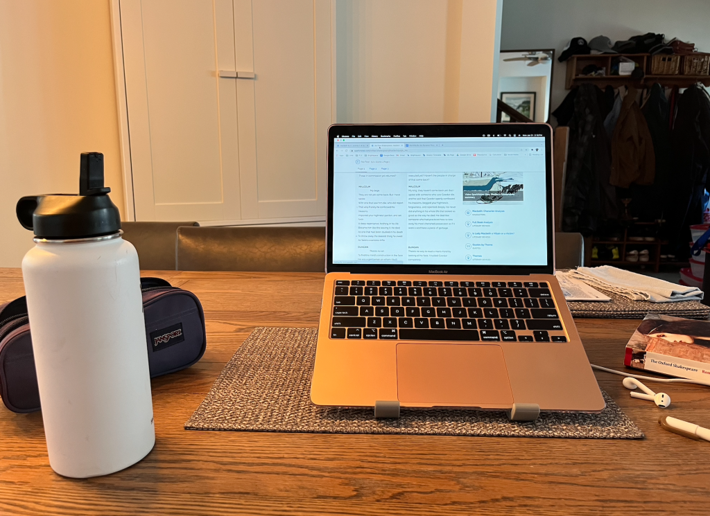water bottle and MacBook at the kitchen table