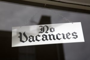 No Vacancies Sign in Hotel Window