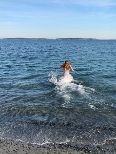 girl running into ocean