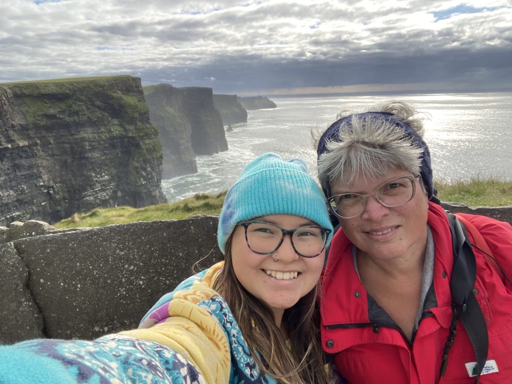 2 women on cliffs overlooking ocean