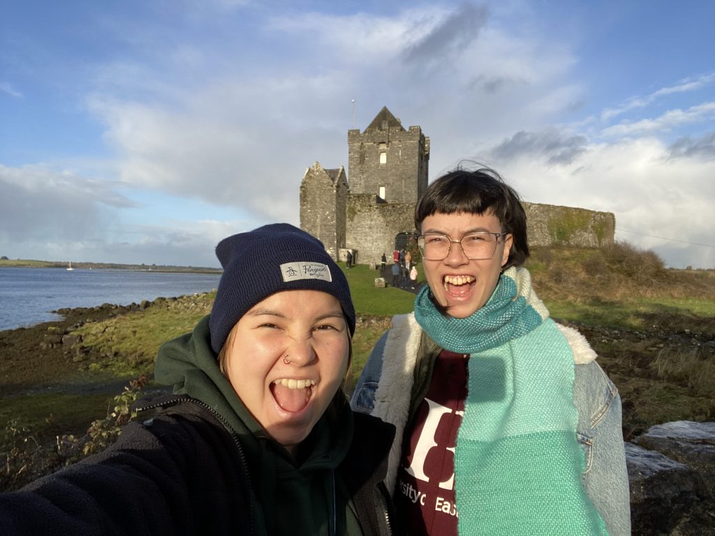 2 women in front of castle
