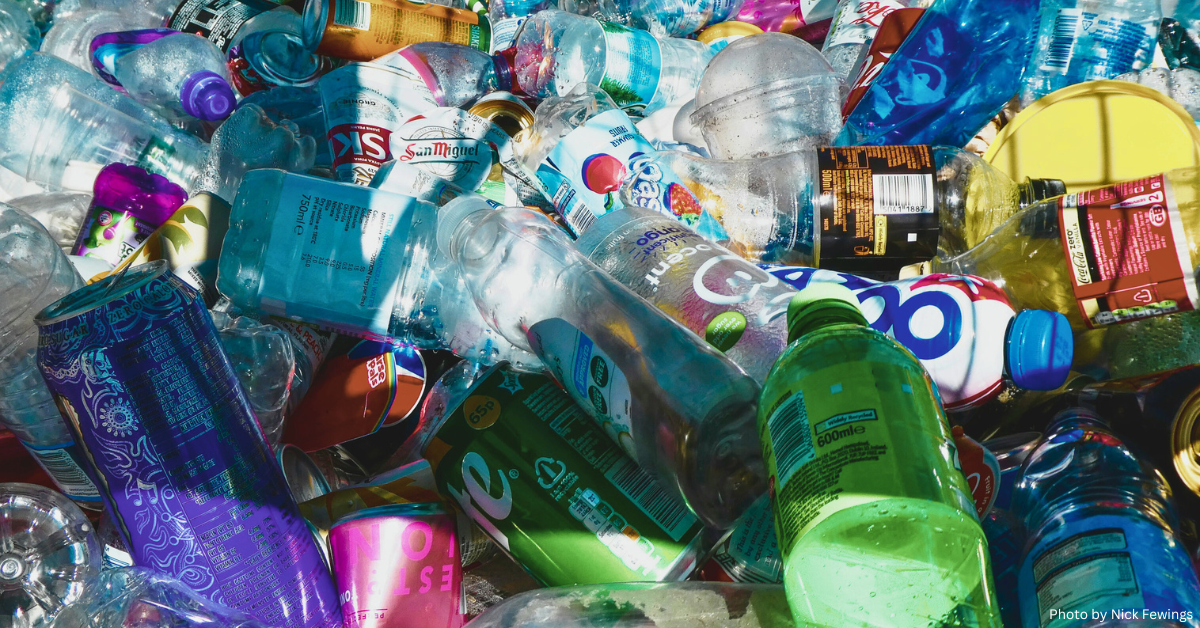A colorful assortment of discarded plastic bottles and cans, illustrating the pressing issue of environmental pollution caused by non-biodegradable waste.