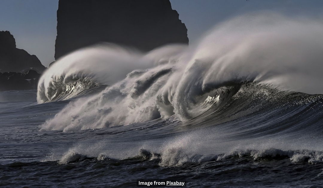 Large waves crashing onto a dark shore.