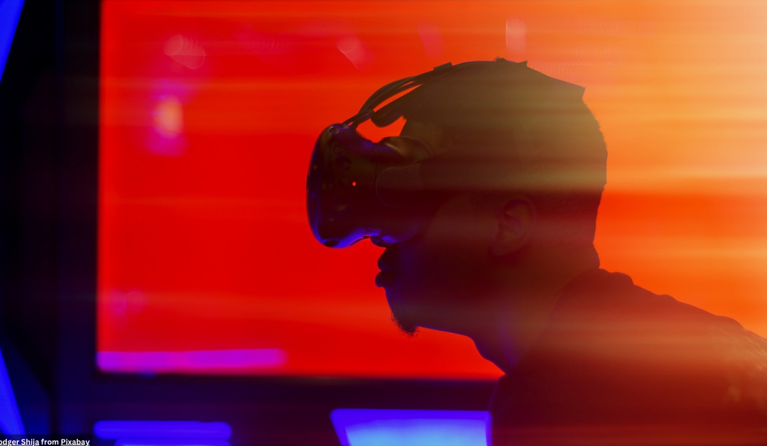 Profile of person with a virtual reality headset on. Orange and blue lights portray a technological ambiance.