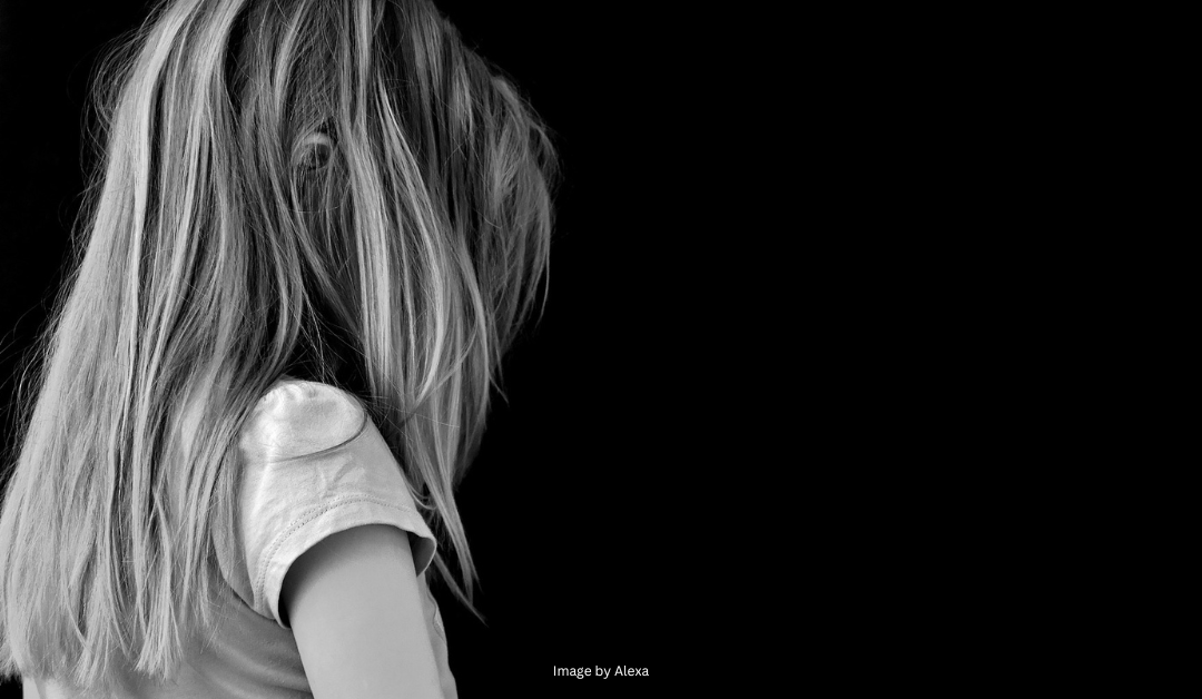 Black and white image of young girl with her back to us