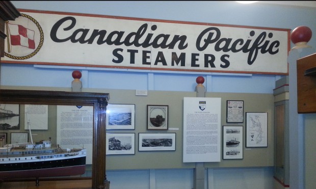 The original CPR sign that hung above the entrance of Victoria Harbor's CPR passenger terminal now hangs above the MMBC's display on the Princess ships. In the bottom left corner, the model of the Princess Alice is visible.