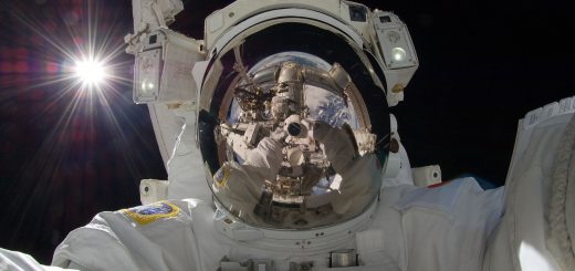 Astronaut floating in space looks into camera