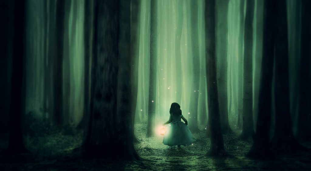 Little girl in a dark forest