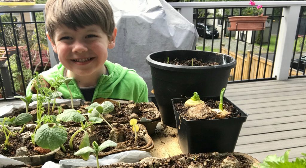 Adrien's son poses with sprouts