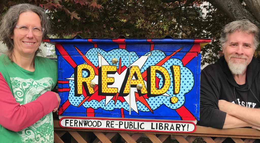 John T and wife pose with book library