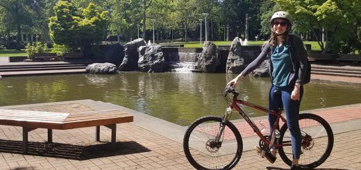 Staiger and her red bike in front of the UVic library fountain in May 2020. Photo credit: Jodie Walsh