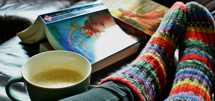 image of book, cup of coffee and feet in comfy socks