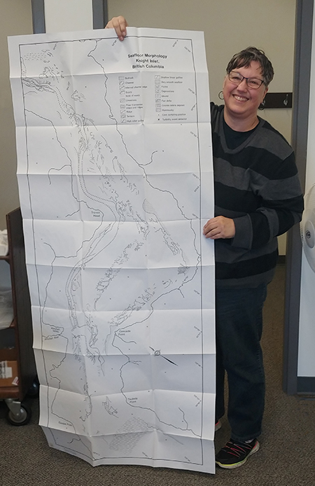 oversized oceanic chart being held by Page DeWolfe